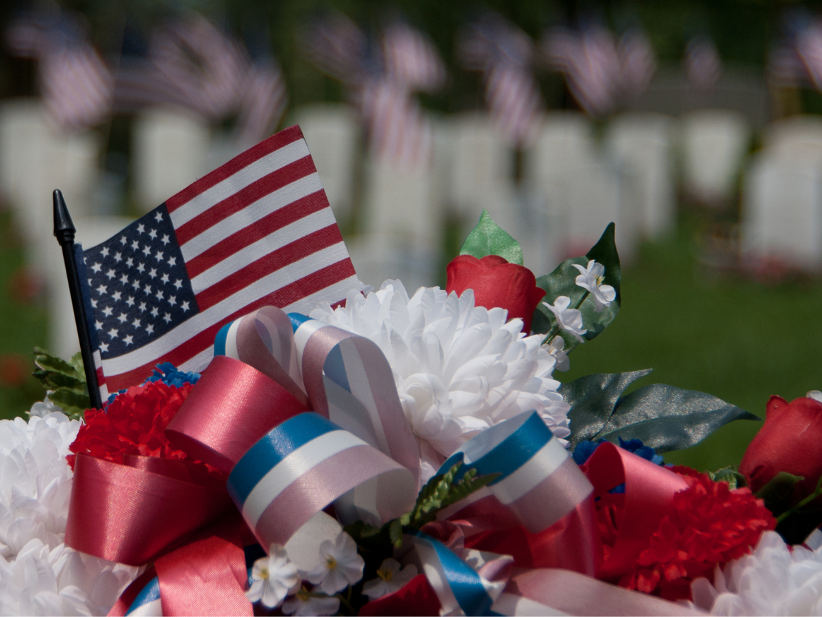 Flowers and flag at a veterans cemetary