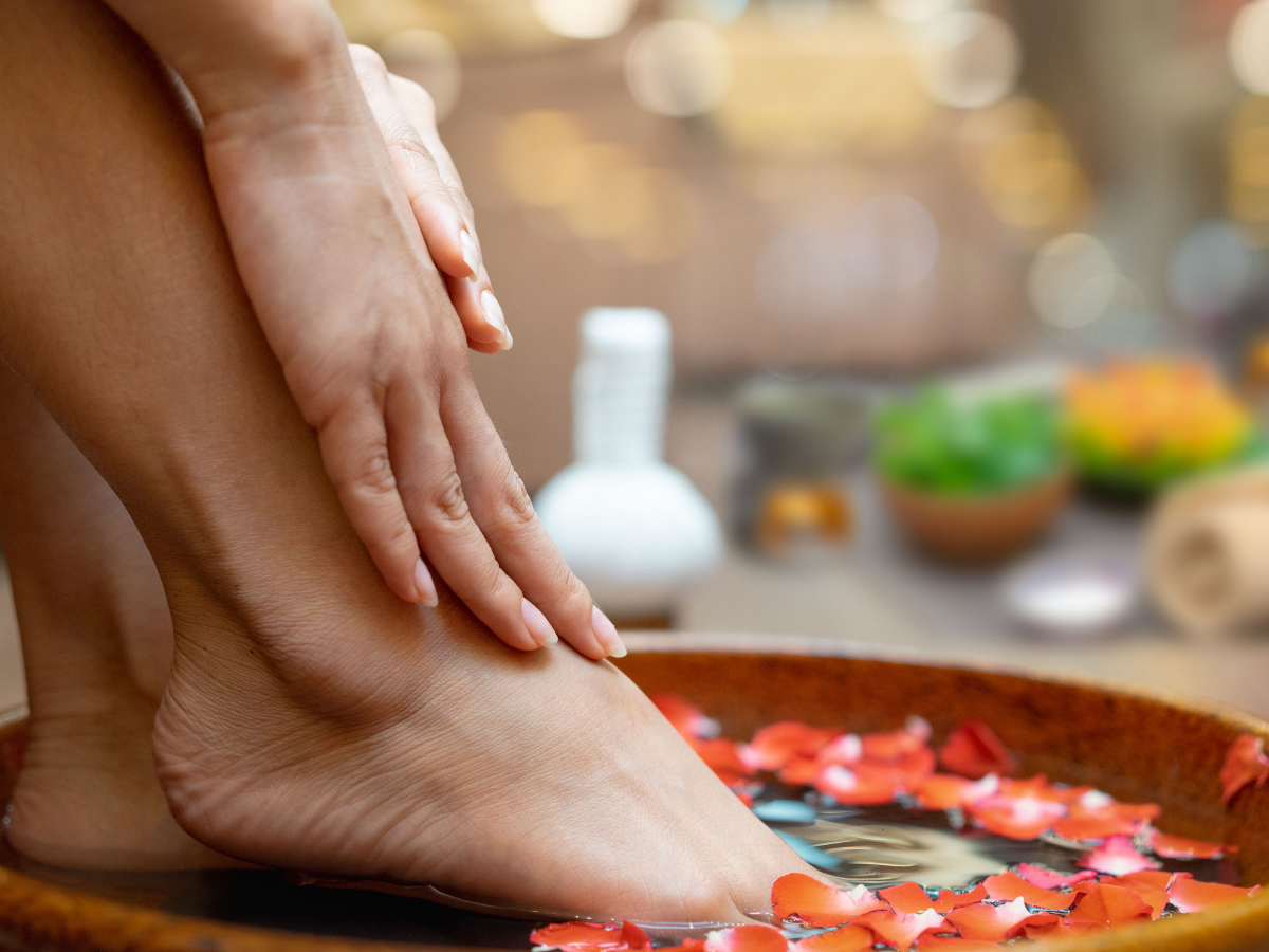 Creating a mini spa feeling by soaking feet in flowered water