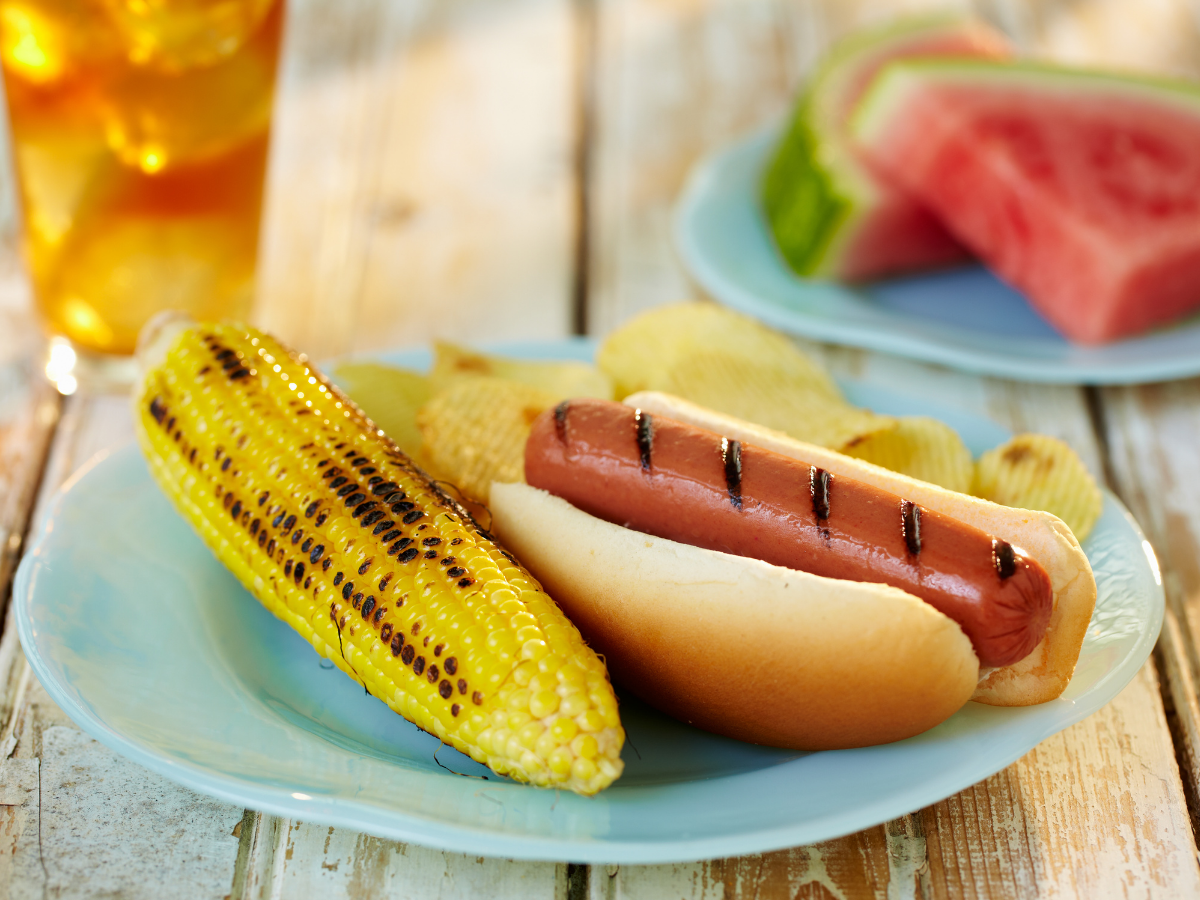 summer meal of a hot dao, corn on the cob and watermelon