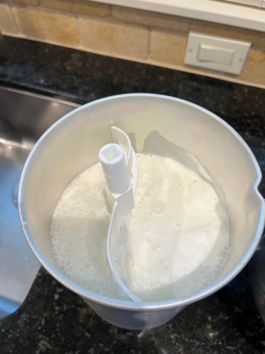 Pour ice cream base into ice cream maker canister.
